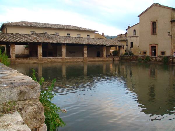 Bagno Vignoni, the thermal pool of Piazza delle Sorgenti among stone buildings