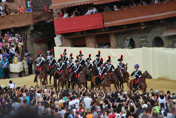Mounted Carabinieri parade in Siena's Piazza del Campo before the crowd