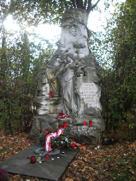 Johann Strauss marble tomb in Vienna, with wreaths and red candles among trees