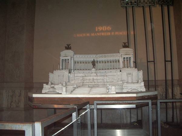 Plaster model of Rome's Vittoriano monument, displayed indoors under warm lighting