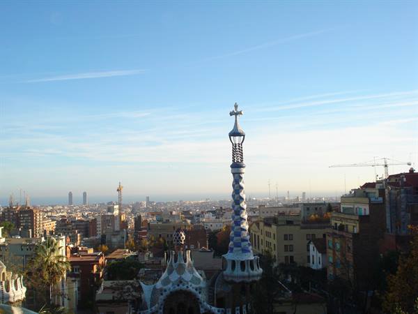 Gaudí's mosaic spire at Park Güell rising above Barcelona rooftops
