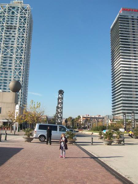 Little girl on the walkway in front of Barcelona's glass towers