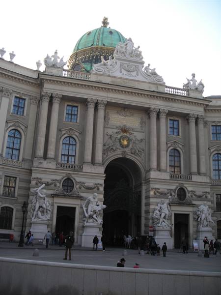 Baroque facade of the Hofburg in Vienna, green dome and marble statues