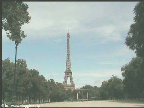 Iron Eiffel Tower seen from Trocadéro gardens among trees