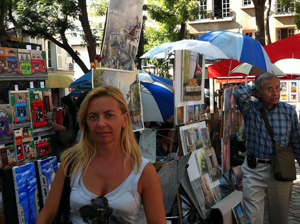 Painters displaying canvases and umbrellas at Place du Tertre, Montmartre, daylight