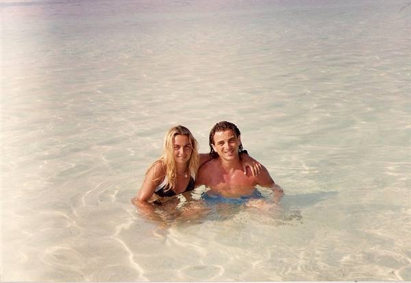 Couple embracing in shallow clear turquoise sea water