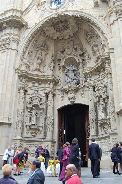 Wedding guests gather at the ornate baroque stone facade of San Sebastián basilica