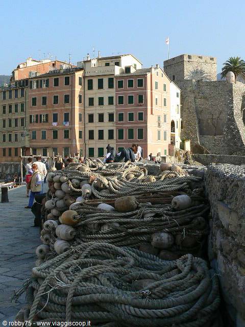 Vernazza: fishing ropes and floats on the pier, colorful houses and castle