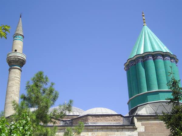 Green tiled dome and stone minaret of the Mevlana Museum in Konya