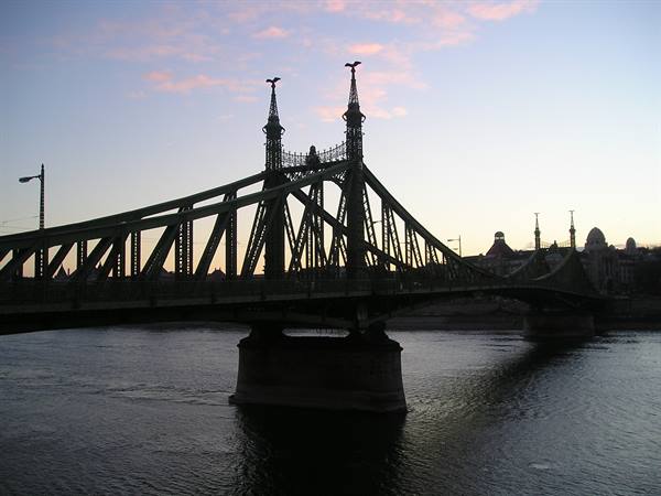 Liberty Bridge in Budapest silhouetted over the Danube at dusk