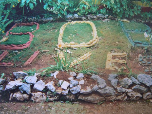 LOVE spelled with colored stones in a green garden