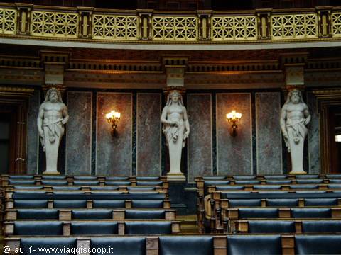 Marble statues and lit lamps inside the Austrian Parliament chamber in Vienna