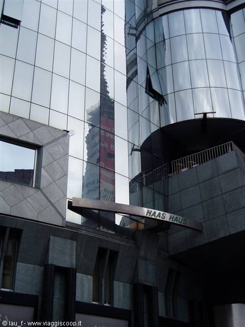 Curved mirrored glass facade of Haas Haus in Vienna, gray reflections