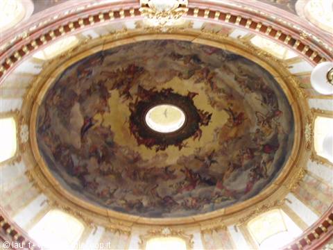Frescoed dome with celestial figures and bright lantern at the center