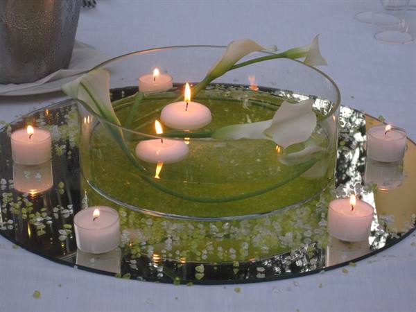 Floating candles and white calla lilies in a glass centerpiece