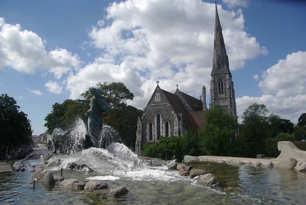 Gefion Fountain bronze statue spraying water, St Alban's Church spire behind