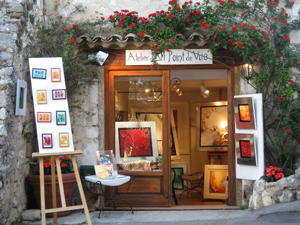 Art shop with easel and paintings under red roses