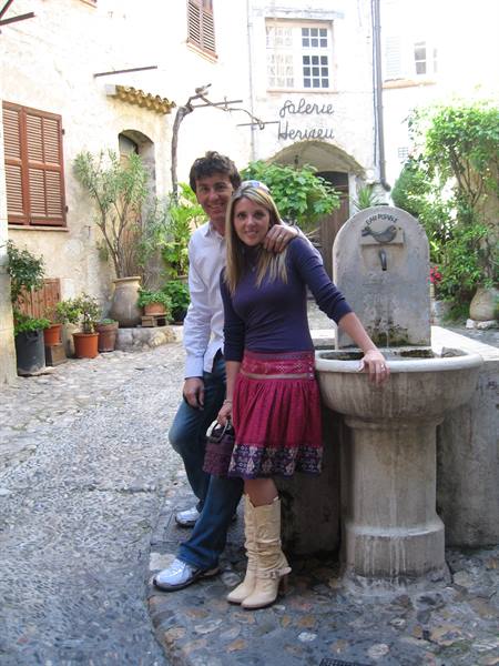 Couple beside old stone fountain on cobbled street, Saint-Paul-de-Vence