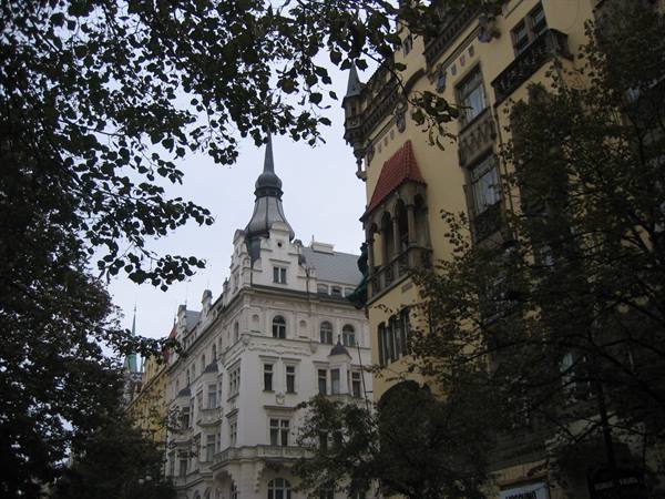 Art Nouveau buildings in Prague framed by tree branches
