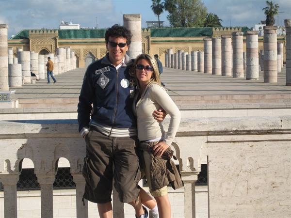 Couple posing among the columns of Hassan II Mosque in Casablanca