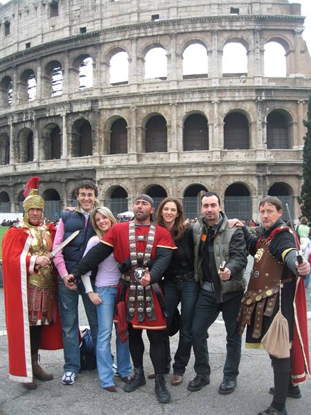 Tourists posing with costumed centurions in front of Rome's Colosseum