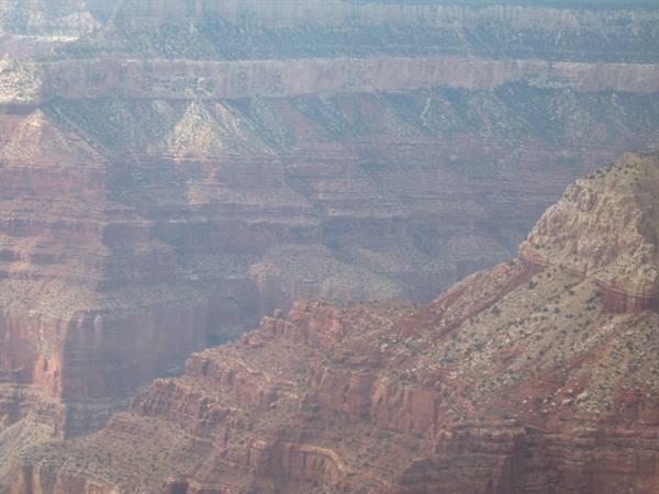 Red rock cliffs of Grand Canyon veiled in daytime haze
