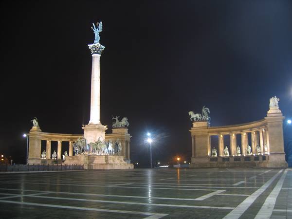 Heroes' Square in Budapest at night, lit millennium column and colonnades
