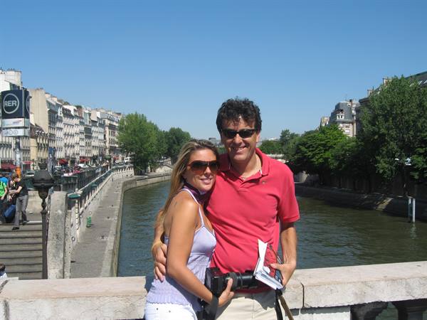 Couple with camera on a bridge over the Seine in Paris