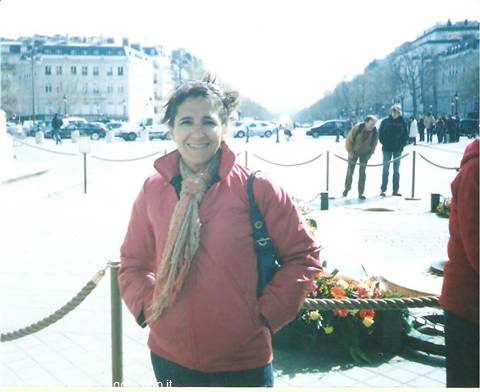 Smiling woman in red jacket and scarf near the Champs-Élysées, Paris