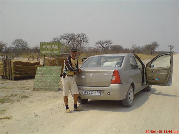Tourist standing by a Renault at Mudumu National Park entrance