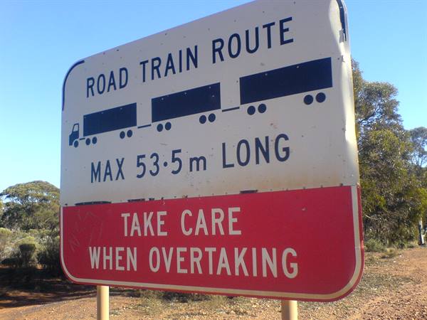 White and red road sign warns of road trains up to 53.5 meters long