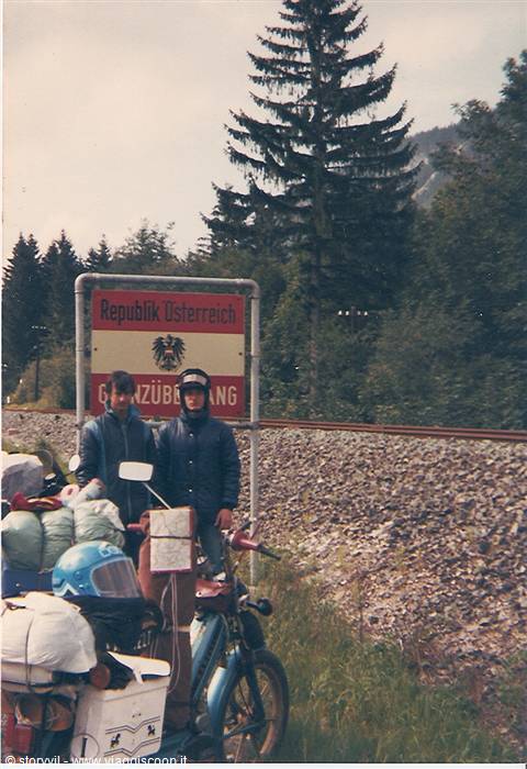 Two travelers with a loaded motorcycle at the Republic of Austria border