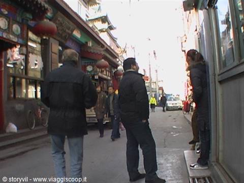 Tourists walking through a shopping street with red lanterns, Beijing