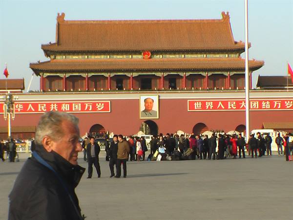 Tourists gathering on the square in front of Tiananmen gate with Mao's portrait