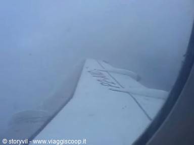 airplane wing seen through the window, covered in fog