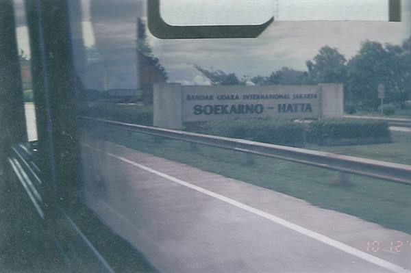 Soekarno-Hatta airport sign seen through a moving car window
