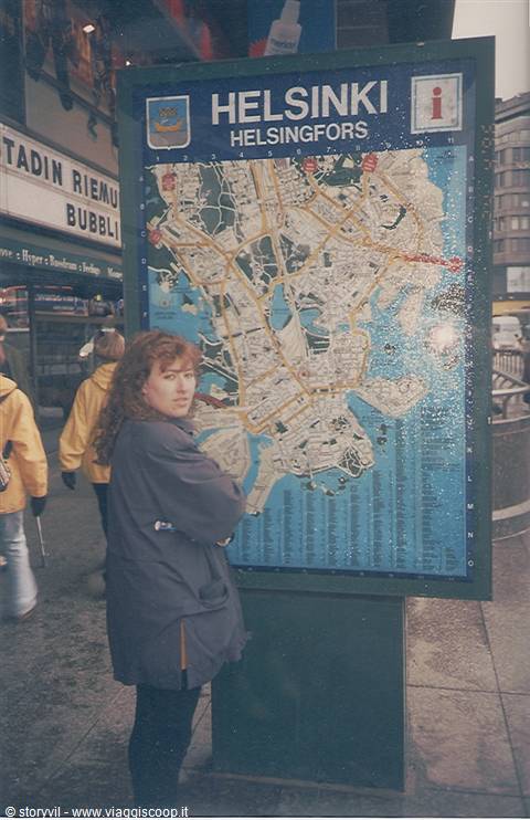 Woman standing in front of the large Helsinki tourist street map