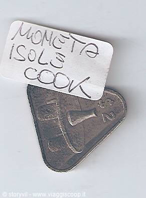 Triangular coin from the Cook Islands with handwritten paper label