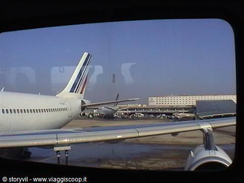 Air France tail through the window, terminal and planes on the apron