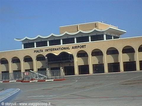 Malta International Airport facade with arched windows and wavy rooftop under blue sky