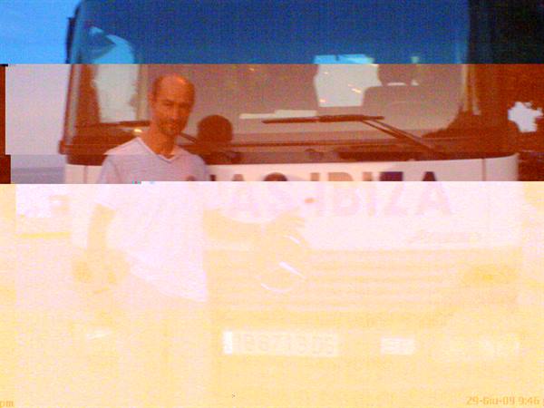 man standing in front of a bus with Ibiza written