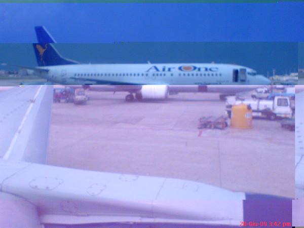 Air One Boeing parked on tarmac, wing and ground vehicles seen from plane