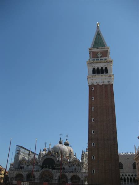 St Mark's brick bell tower beside the golden-domed basilica, Venice
