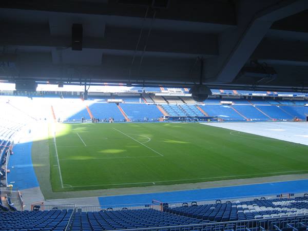 Santiago Bernabéu stadium, green pitch and empty blue stands
