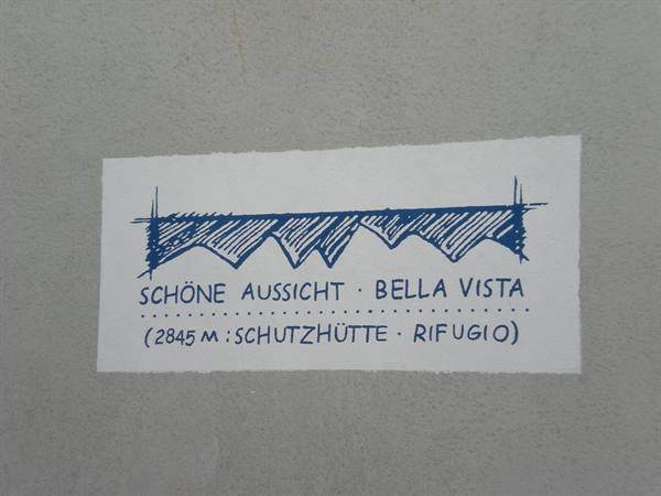 Hand-painted sign marks the Schutzhütte mountain hut at 2845 meters