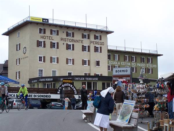 Hotel Ristorante Perego at Passo dello Stelvio, cyclists and tourists browsing souvenir stalls