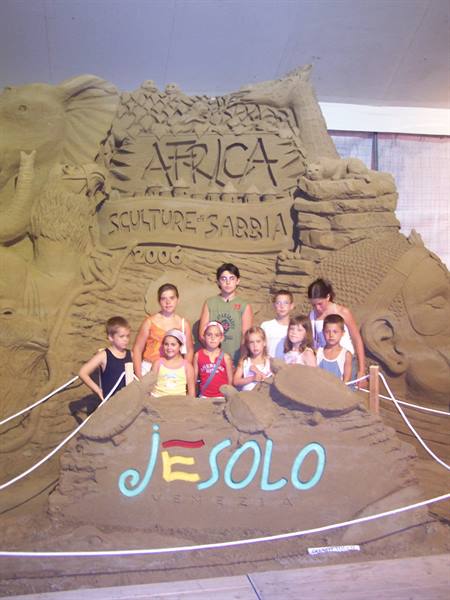 Children posing in front of the Africa sand sculpture in Jesolo