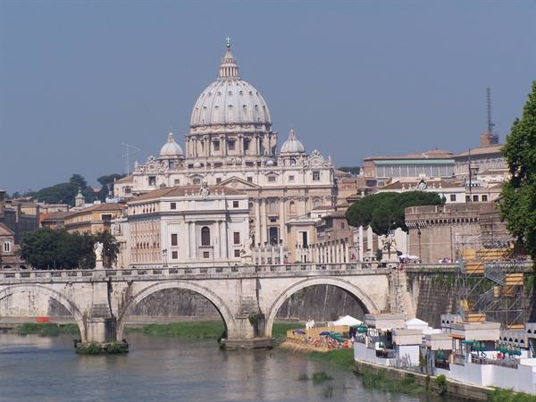Travertine arched bridge and St Peter's dome across the Tiber
