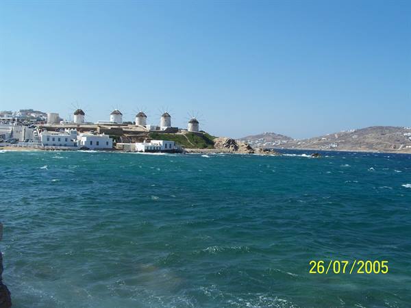 The white windmills of Mykonos above the blue sea