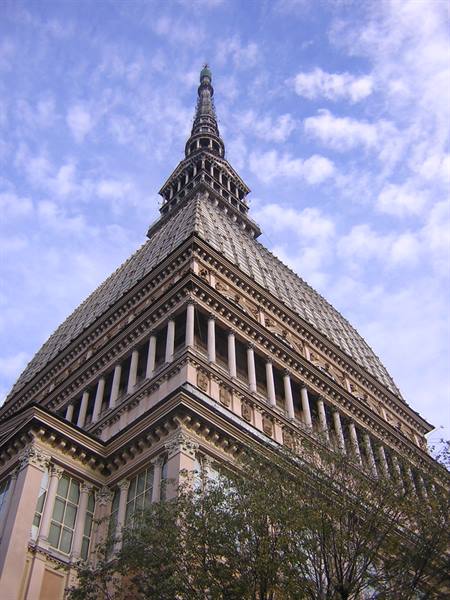 Turin's Mole Antonelliana, brick spire rising against a cloudy sky